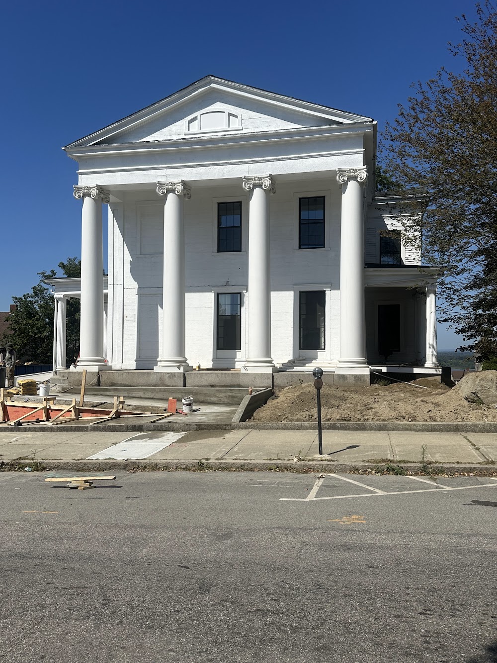 White classical-style building exterior photographed during construction